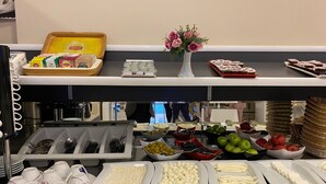 A buffet setup with various food items and utensils. - Magnaura House Hotel (Istanbul)