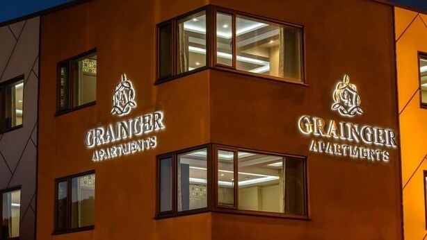 A building with the sign 'GRANGER APARTMENTS' illuminated. - Grainger Apartments (Newcastle-upon-Tyne)