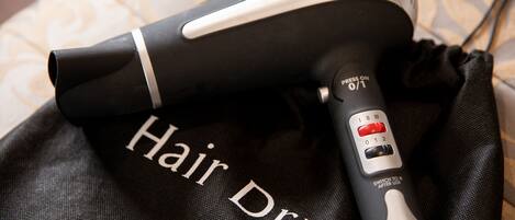 A hair dryer with a control panel and a black bag with "Hair Dryer" written on it.