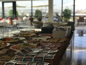 A buffet setup with various food items and condiments. - Bugday Hotel (Ankara)