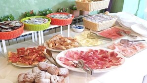 A buffet with various food items including meats, cheeses, and pastries. - Hotel Rita (Cervia)