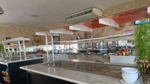 A modern kitchen area with stainless steel appliances, a central island, and a potted plant. - Resort Hotel Atlantic City Náutico Clube (Teresina)