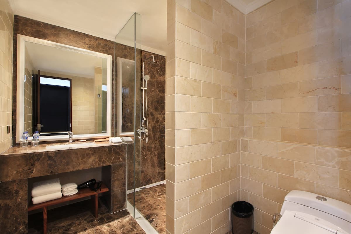 shower, hair dryer, slippers, towels