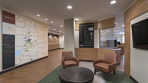 A lobby with a map, chairs, a round table, and a sign about Lakewood, WA. - TownePlace Suites by Marriott Tacoma Lakewood (Lakewood)