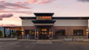 A steakhouse with a modern facade, a clear entrance, and a parking area with handicapped accessibility. - Best Western Plus Merritt Hotel (Merritt)