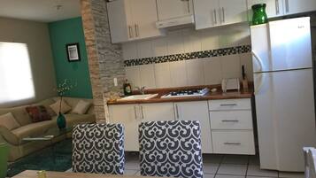 Full-sized fridge, microwave, stovetop, cookware/dishes/utensils