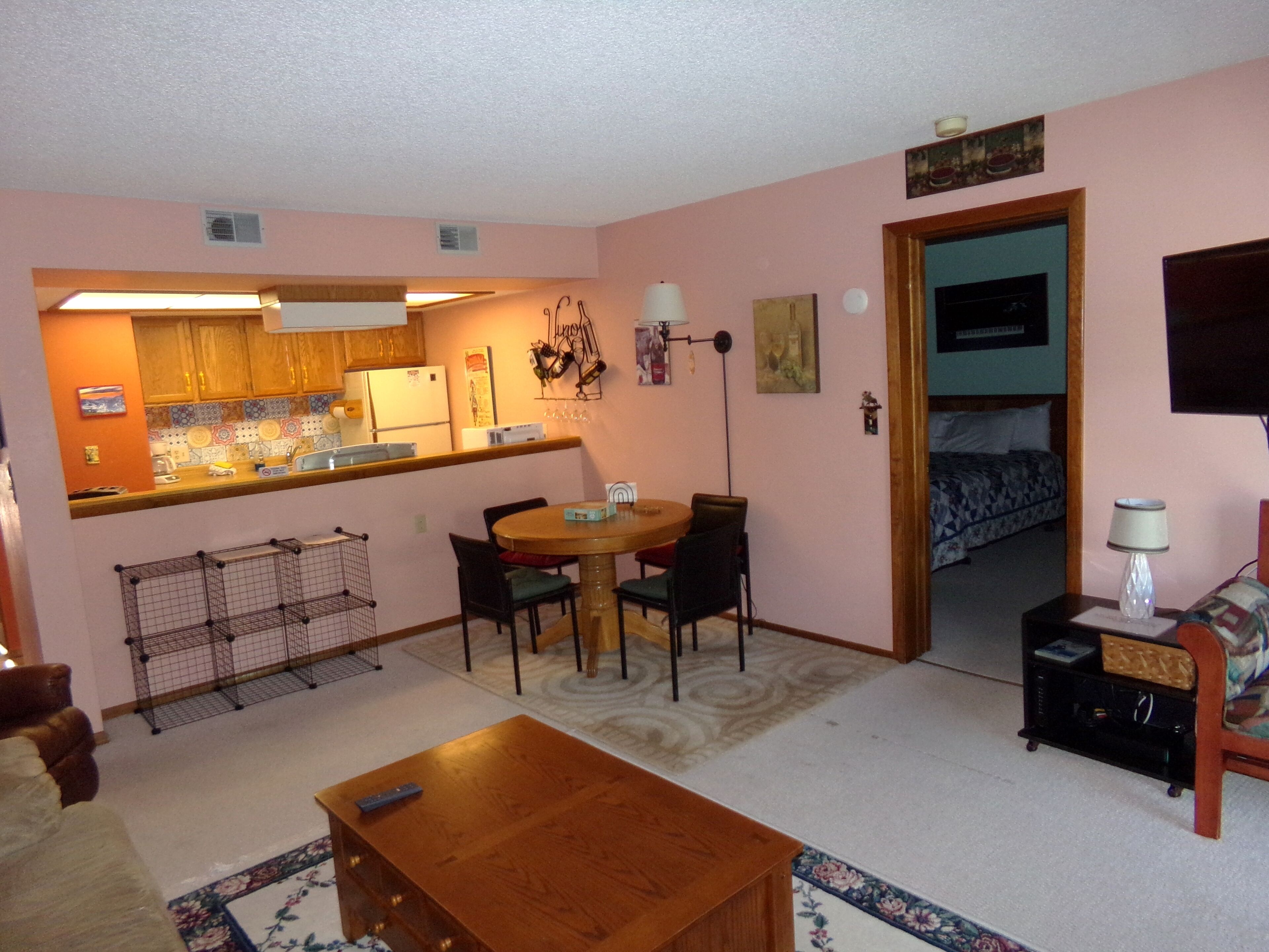 A compact living space with a kitchen, dining area, and a bedroom.