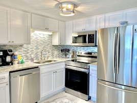 Condo, 2 Bedrooms, Balcony, Beachfront (202) | Private kitchen | Coffee/tea maker, full-sized fridge, microwave, oven