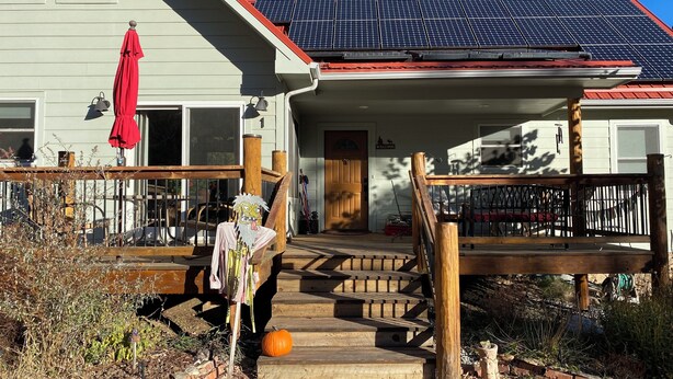 A house with a solar panel roof, a wooden deck, and a front porch. - Private room & bath in Rocky Mt foothills with kitchenette, private entrance! (Jamestown)