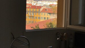 A bathroom with a window view of a cityscape and hills. - New bulding in the old twon of Nice, 750 meter to castel beach (Nice)