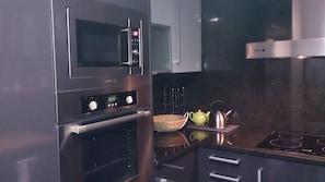 Enjoy cooking in this well-equipped kitchen with a microwave, oven, and stove.