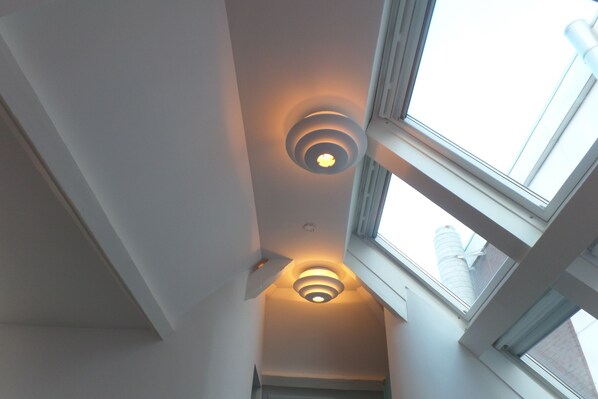 A skylight with a circular design and a window with a white frame.