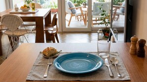 A dining table with a blue plate, cutlery, and a loaf of bread. - Appartamento Gassman - Holiday Apartment in Milano (Milano)