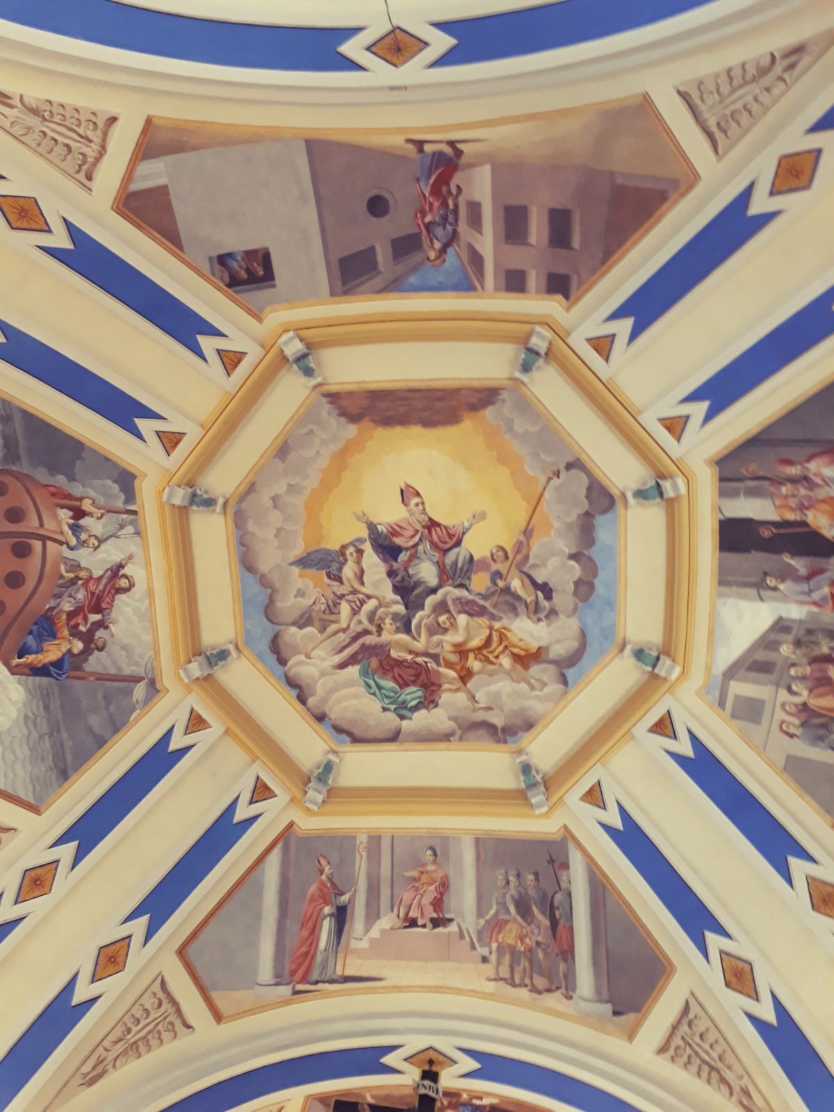 A detailed ceiling fresco with religious figures and architectural elements.