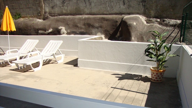 A pool area with white lounge chairs and a yellow umbrella. - Aracelli T2 apartment with terrace and balcony.  (Ermesinde/Porto)
