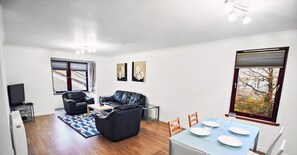 Deluxe Apartment, 2 Bedrooms | Living room | Flat-screen TV, DVD player