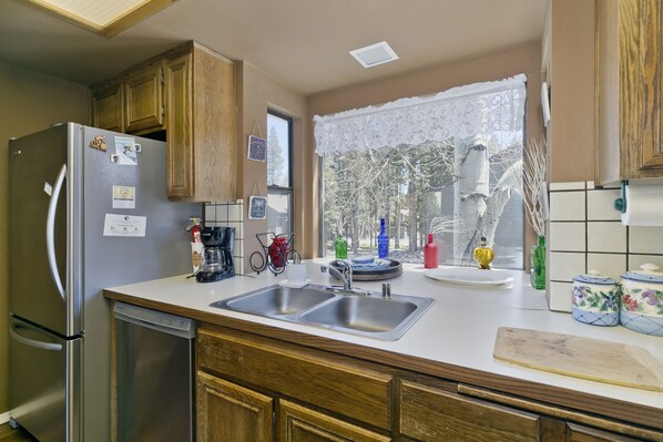 Enjoy cooking in this well-appointed kitchen with a double sink, dishwasher, and ample counter space.