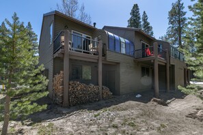 Experience the unique blend of natural surroundings and modern architecture in this two-story residence, featuring spacious balconies and large windows.