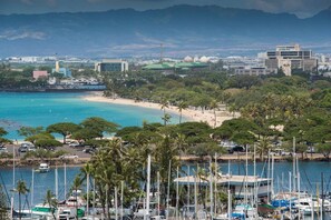 A coastal area with a beach, boats, and a marina.