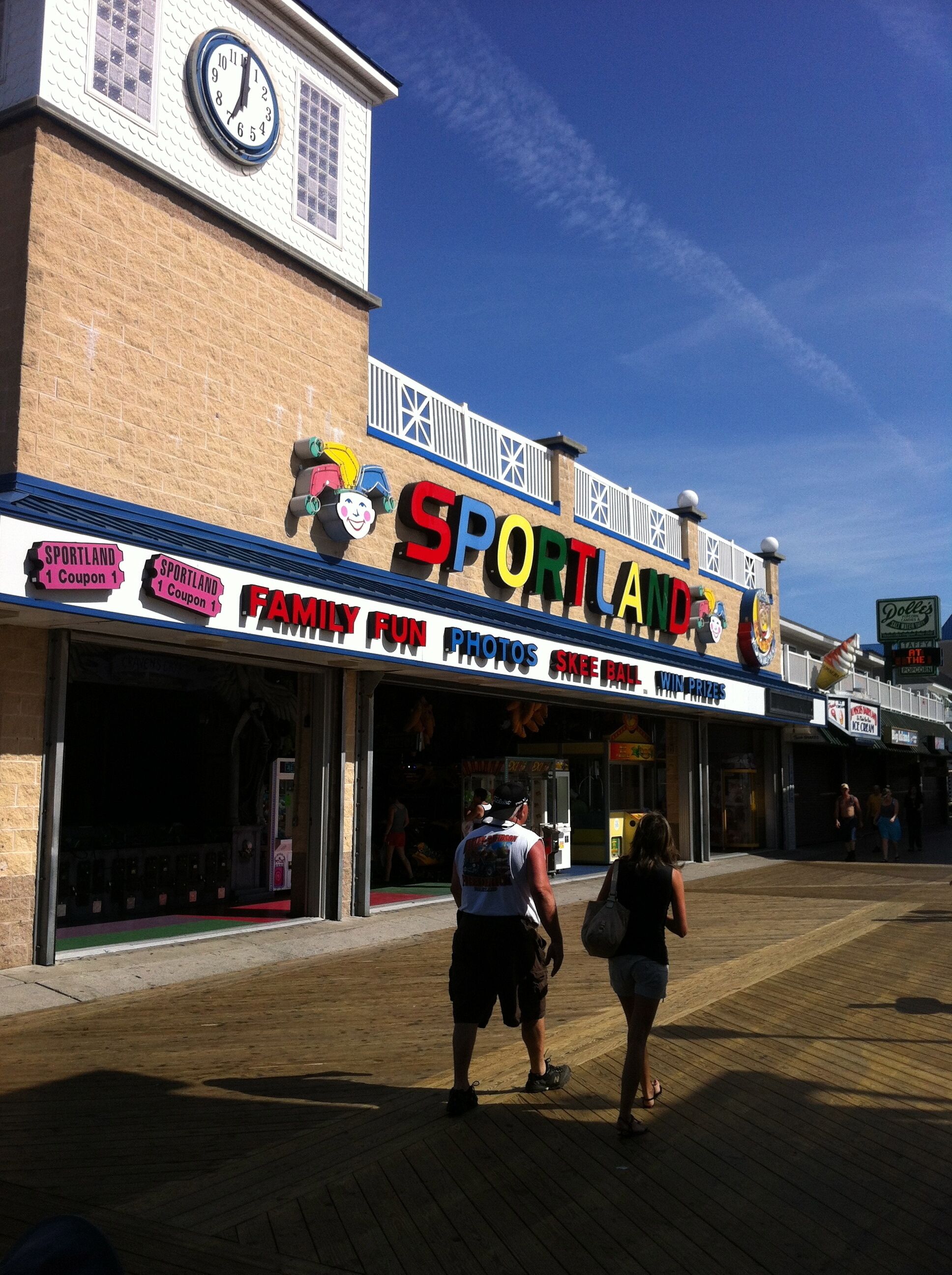 A storefront with a sign reading "SPORTLAND" and "FAMILY FUN PHOTOS."