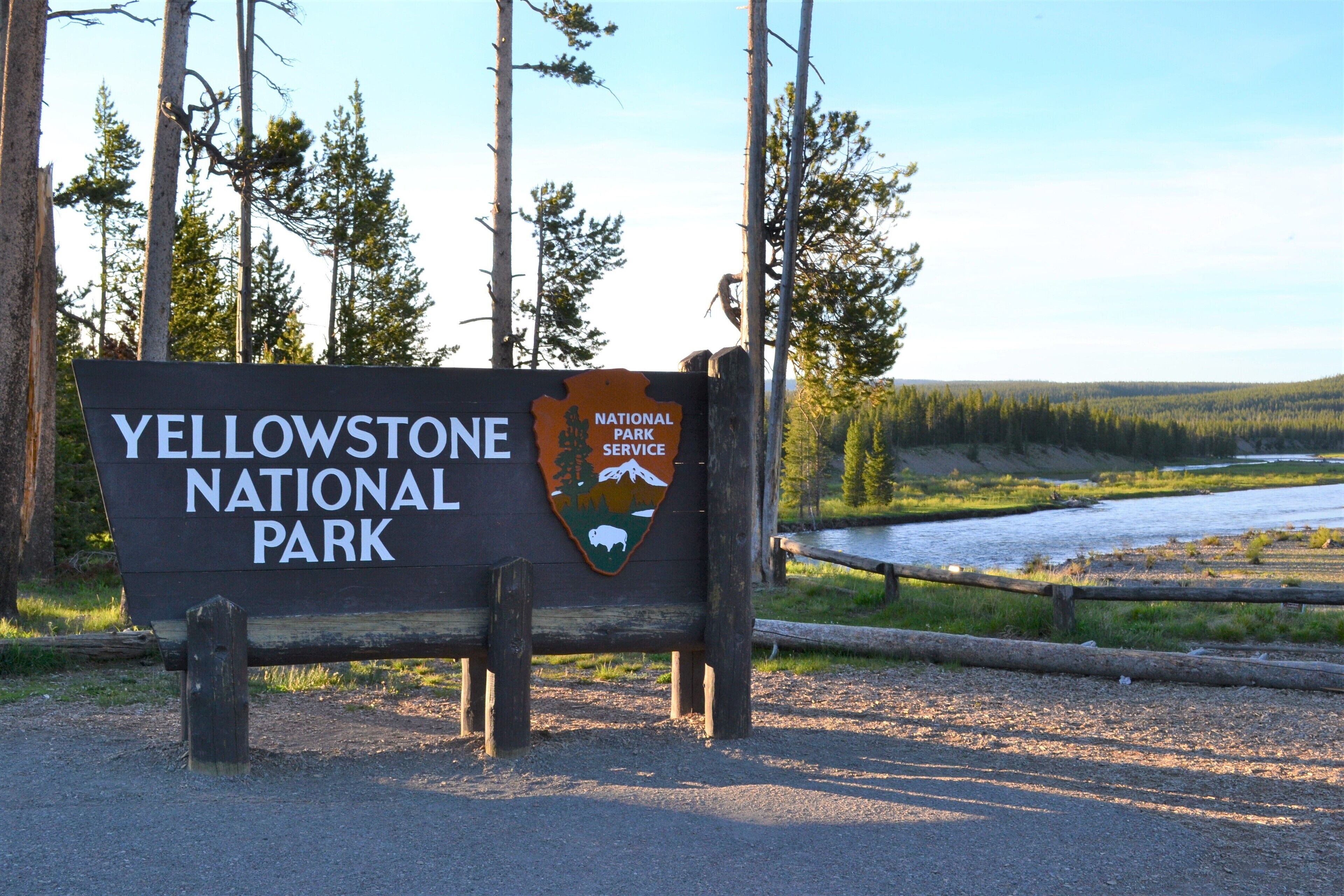 A sign for Yellowstone National Park with a logo and the name of the park.