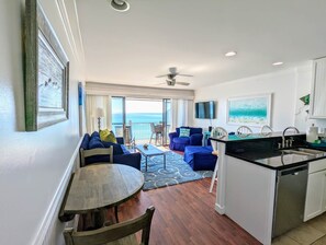 Living room, dining area with view to balcony