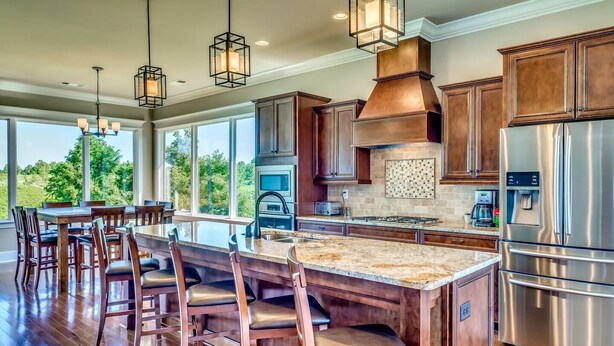 A spacious kitchen with a large island, wooden cabinets, stainless steel appliances, and pendant lighting. - 2nd House Built For Groups - 4 Suites, 8 Beds, WOW (Prattville)