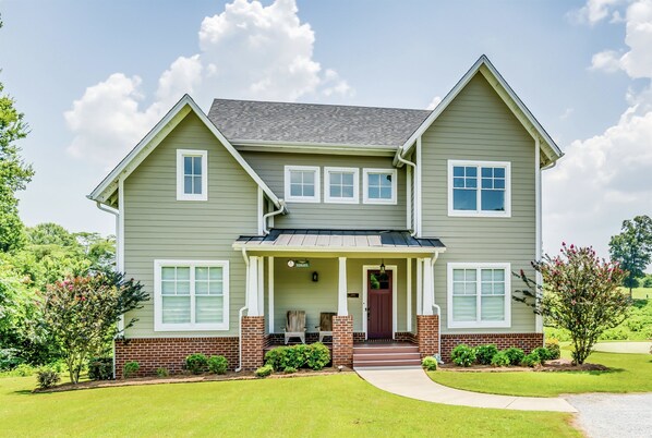 A two-story house with a front porch, brick foundation, and a well-maintained lawn. - 2nd House Built For Groups - 4 Suites, 8 Beds, WOW (Prattville)