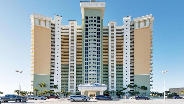 A multi-story hotel with a central entrance and balconies on each floor. - Boardwalk Luxury Condo - Free Wifi, Beachfront, 4th Floor, Great Amenities! (Panama City Beach)