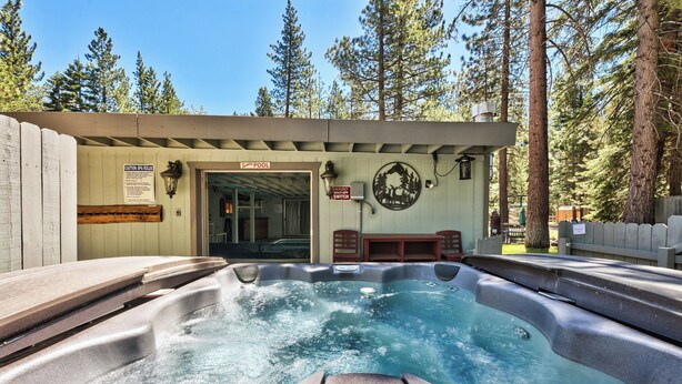A hot tub area with a sign indicating a pool switch, surrounded by trees. - TAHOE RANCH, SUMMERTIME POOL, HOT TUB, ON RIVER, 3BD, 2 BA, FAMILY & DOG OK WALK (South Lake Tahoe)