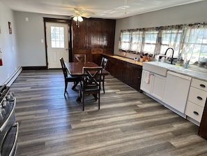 Enjoy meals with family and friends at the dining table for four, surrounded by modern appliances and ample storage.