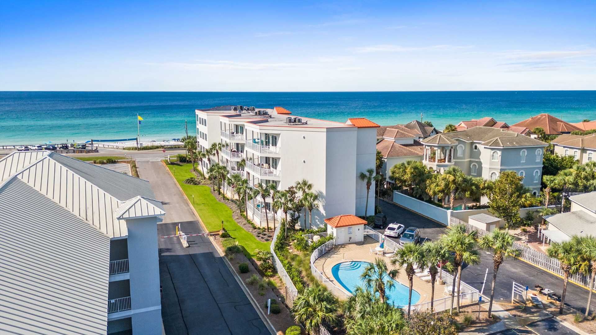 A hotel with a pool, beachfront view, and multiple buildings with balconies.