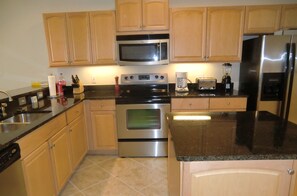 Enjoy cooking in this fully equipped kitchen with a refrigerator, microwave, oven, and toaster.