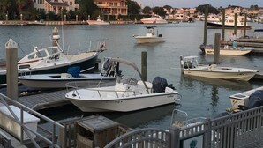 A marina with several boats docked, a wooden dock, and a sign indicating a private dock. - Isle of Palms - 3rd Floor Ocean Front with Private Balcony, Pool, and Pier  (Isle of Palms)