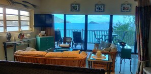Relax in style with a comfortable seating area, perfect for unwinding with a view of the sea and surrounding mountains.