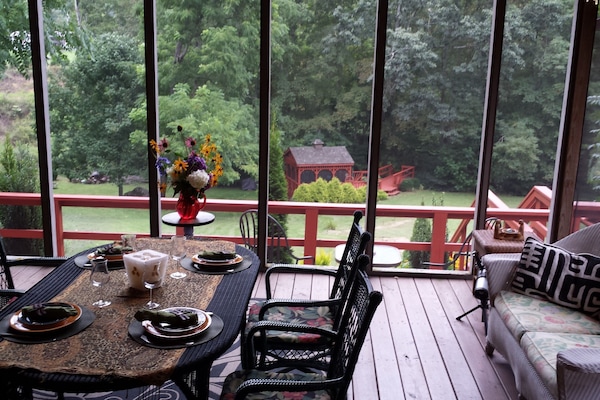 Screen porch, looking down to the gazebo and the creek.