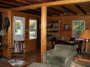 Relax in a cozy seating area with a comfortable armchair and enjoy meals at the dining table.