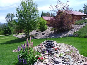 Stroll through the beautifully landscaped garden, featuring a variety of plants and a serene water feature.