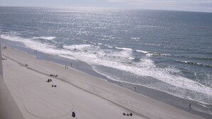 A beach with a wide sandy shore and gentle waves. - Ocean Front-BRIGADUNE 14E Paradise on Shore Drive Family friendly  (Myrtle Beach)