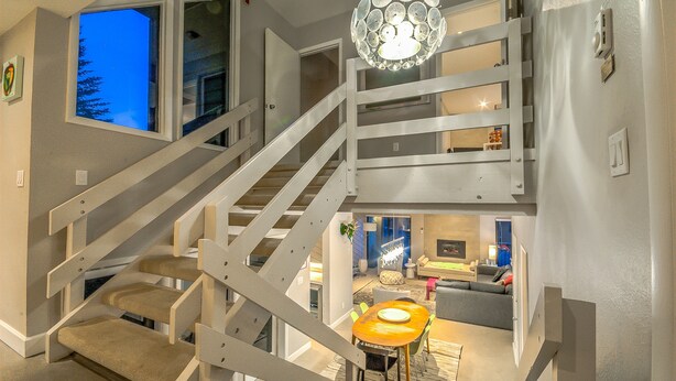 A multi-level interior with a staircase, a dining area, and a living room. - Spacious 2-Bedroom + 3-Bath Condo | 200 Yards from the Slopes! (Steamboat Springs)