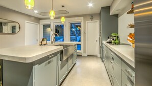 A modern kitchen with a central island, stainless steel appliances, and pendant lighting. - Spacious 2-Bedroom + 3-Bath Condo | 200 Yards from the Slopes! (Steamboat Springs)