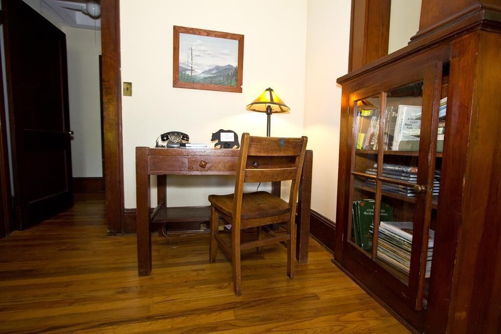 Arts & Crafts original desk/ info center welcome you to The Chestnut Log Cabin