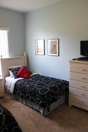 A bedroom with a bed, a dresser, and two framed pictures on the wall. - Dog friendly! Super Quiet, Pool, Close to Disney, Indoor Game Room, 2 Masters (Davenport)
