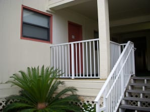 Stunning exterior of a residential building with a charming entrance and lush greenery.
