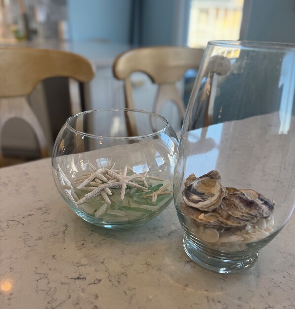 Two glass bowls on a marble countertop, one containing starfish and the other containing oysters. - Ocean-view, family-friendly, walking access to charming town and marina (Southport)