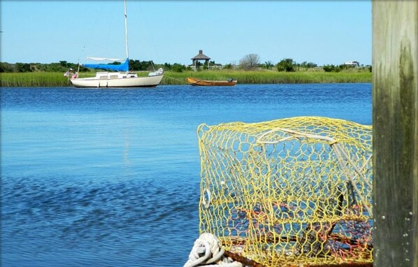 A calm water body with boats and a fishing net. - Ocean-view, family-friendly, walking access to charming town and marina (Southport)