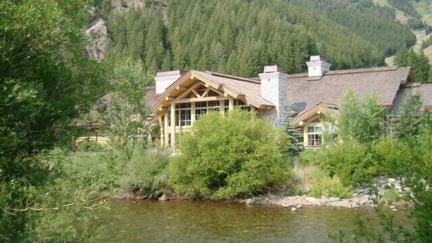 A lodge with a large wooden structure, a chimney, and a river in front. - SV137 - Walk to Lifts & Town - Hot Tub & Pool (Ketchum)