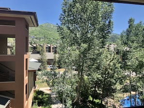Stunning hillside views surround this residential area, featuring modern buildings with spacious balconies and large windows.