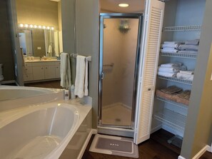 A bathroom with a bathtub, a shower, a vanity with a mirror, and a towel rack. - TOP Rated Premium Costal Family Retreat with Heated Pool & Private Golden Beach (Venice)