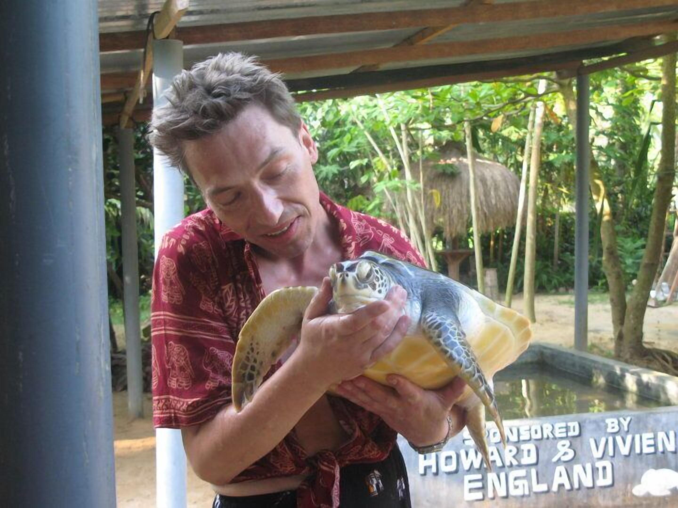 A person holding a turtle.